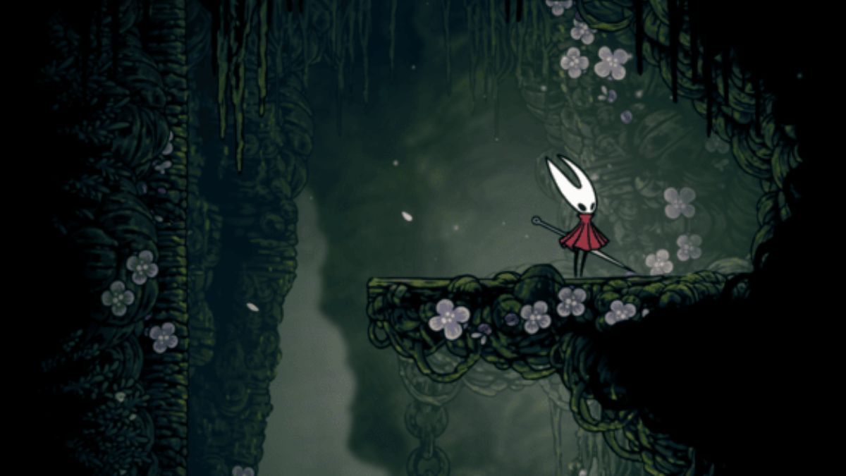 Hornet, the protagonist of Hollow Knight: Silksong, stands on a platform in the lush, moss-covered region of Shellwood, surrounded by small white and purple flowers. The art style emphasizes the dense, overgrown nature of the environment.