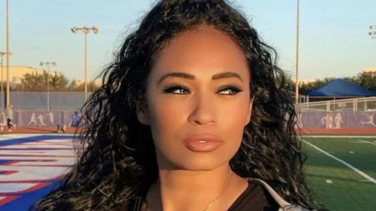 Deion Sanders (Coach Prime) smiling and looking sharp in a suit, reflecting his determined public image despite recent health challenges.