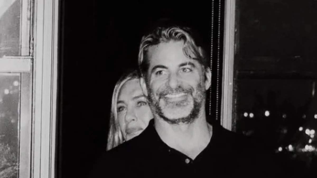 Close-up of Jennifer Aniston hugging Jim Curtis from behind, showing their warm smiles during their November 2, 2025, Instagram official debut.