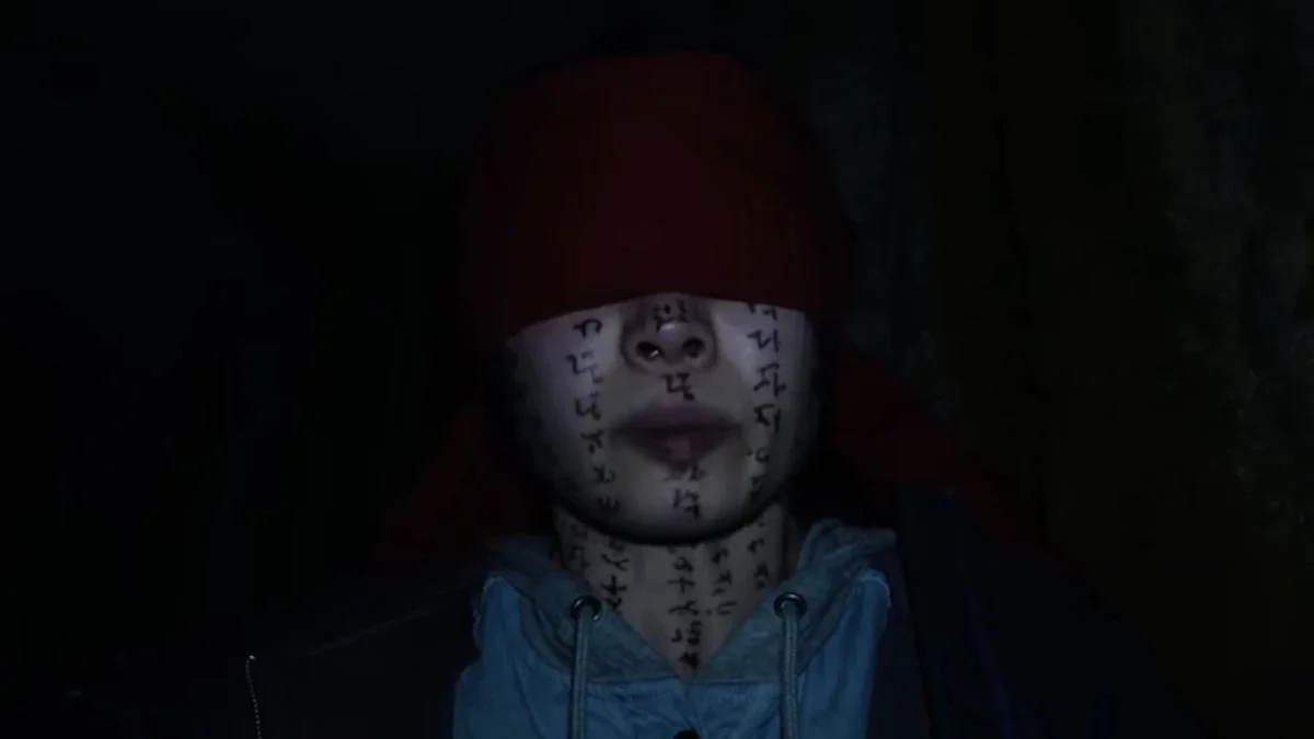 A cursed character, blindfolded with a red cloth and covered in dark ritualistic runes, from the Taiwanese horror film Incantation (2022).