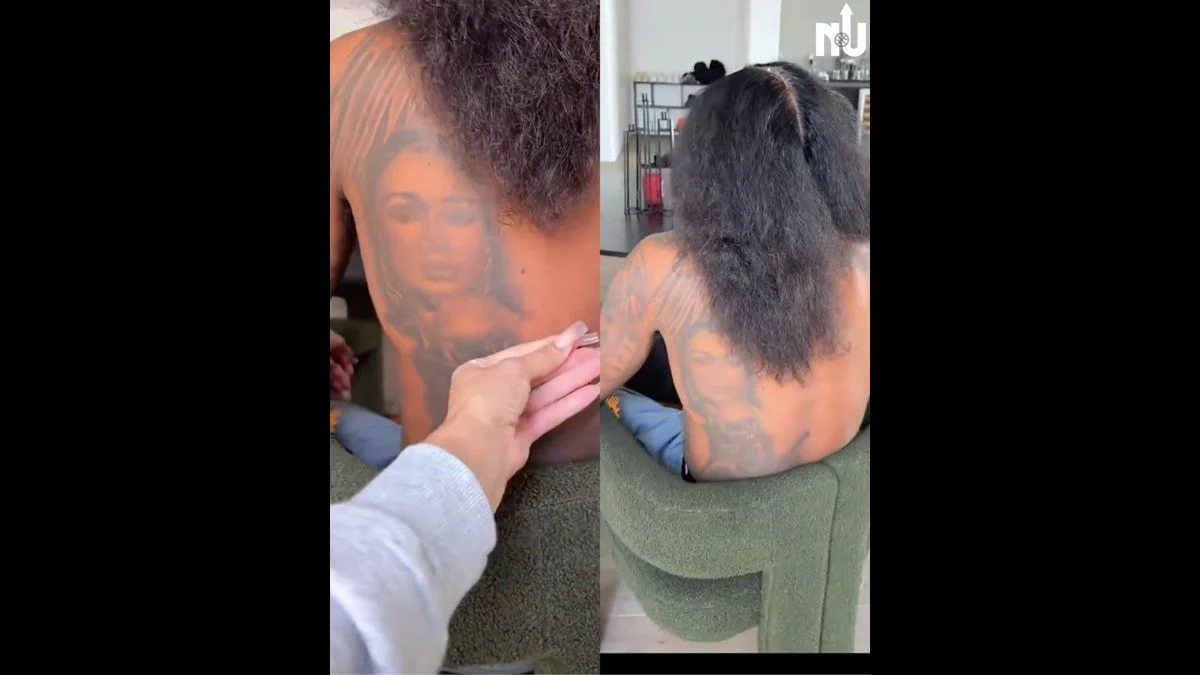 NBA player Jalen Green and Draya Michele posing closely together at a public event, both wearing white-themed outfits.