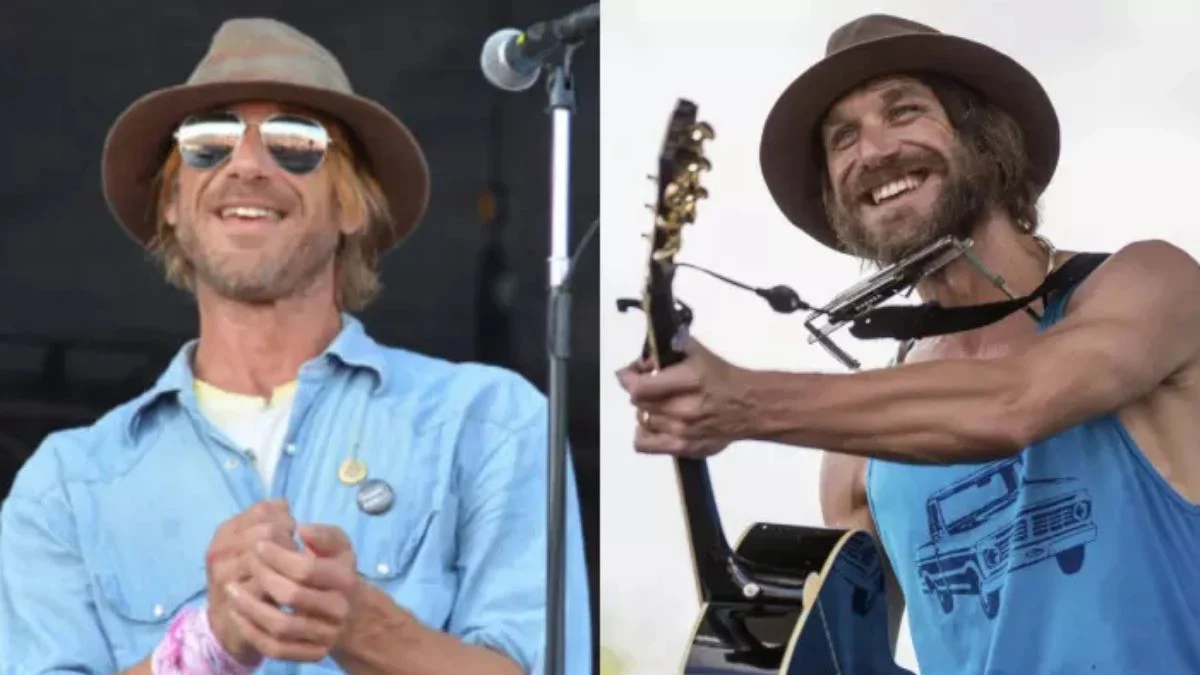 Singer-songwriter Todd Snider performing on stage, smiling and wearing a hat, before the violent assault and subsequent arrest that led to his tour cancellation.
