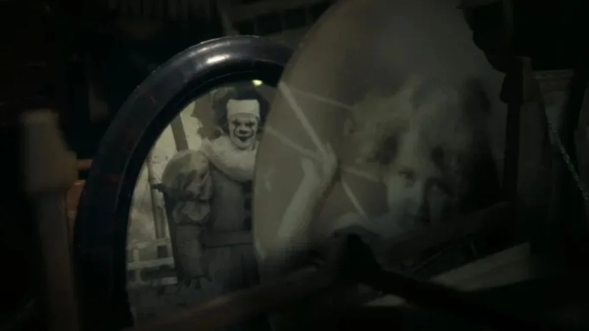 Bill Skarsgård as Pennywise the Dancing Clown reflected in a dark, vintage mirror in the IT: Welcome to Derry series.