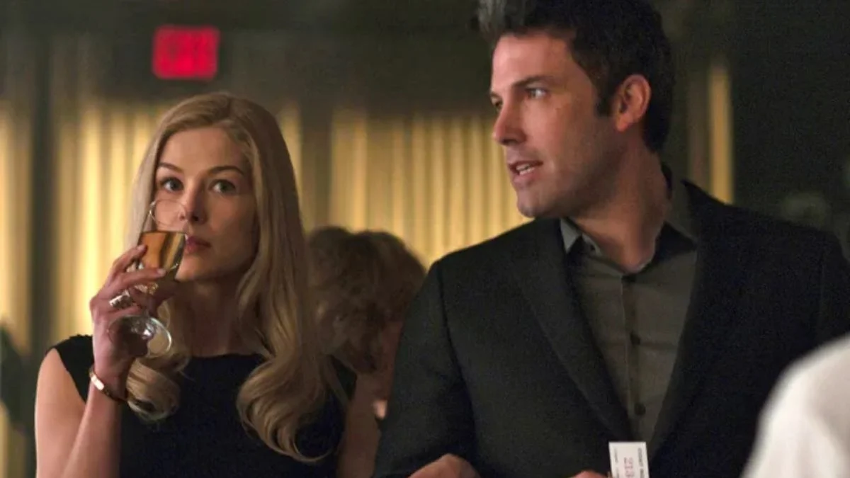 Nick and Amy Dunne, played by Ben Affleck and Rosamund Pike, at a party in a scene from the movie Gone Girl.