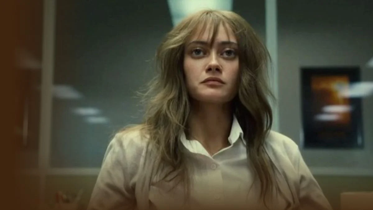 Ella Purnell as Rhiannon Lewis staring intensely in a white shirt in Sweetpea Season 1.