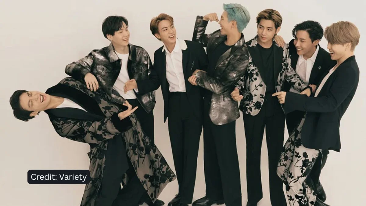 All seven members of BTS laughing and posing together in floral patterned suits for a Variety photoshoot.