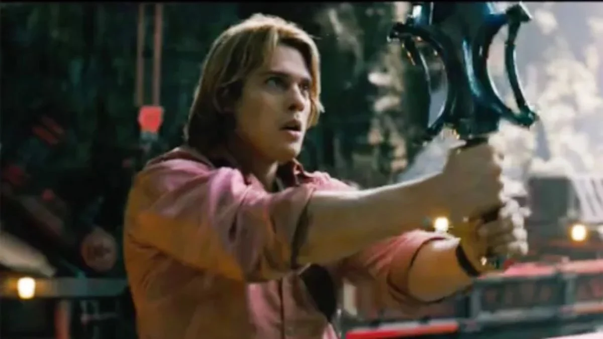 Nicholas Galitzine as Prince Adam holding the Power Sword of Grayskull