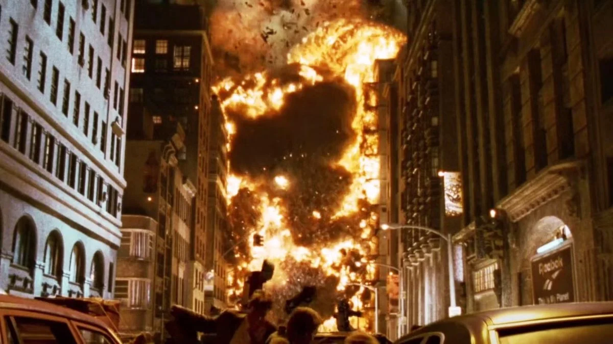 A massive wall of fire and explosions destroying city buildings in the 1996 sci-fi disaster movie Independence Day.