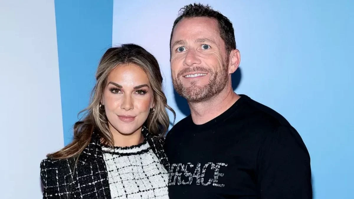 Allison Holker and fiancé Adam Edmunds smiling together at a red carpet event.