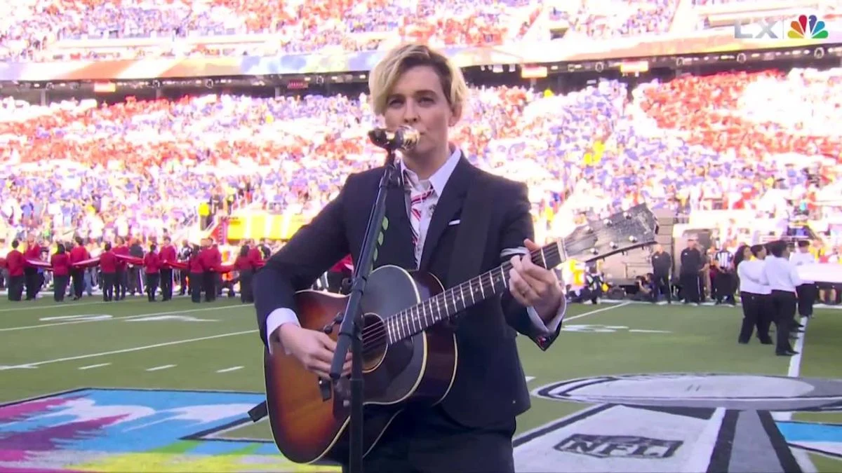 Brandi Carlile performing America the Beautiful with an acoustic guitar at Super Bowl LX.