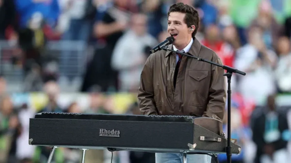 Charlie Puth singing and playing a black Rhodes keyboard during the Super Bowl LX National Anthem.