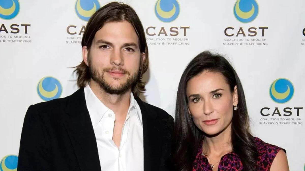 Demi Moore and Ashton Kutcher posing together at a CAST (Coalition to Abolish Slavery & Trafficking) event, showcasing their early relationship and shared philanthropic work.