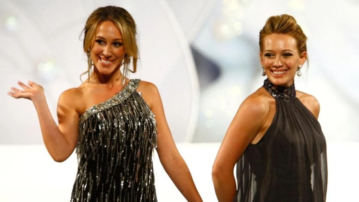 Hilary Duff and Haylie Duff smiling together in formal attire at a red carpet event.