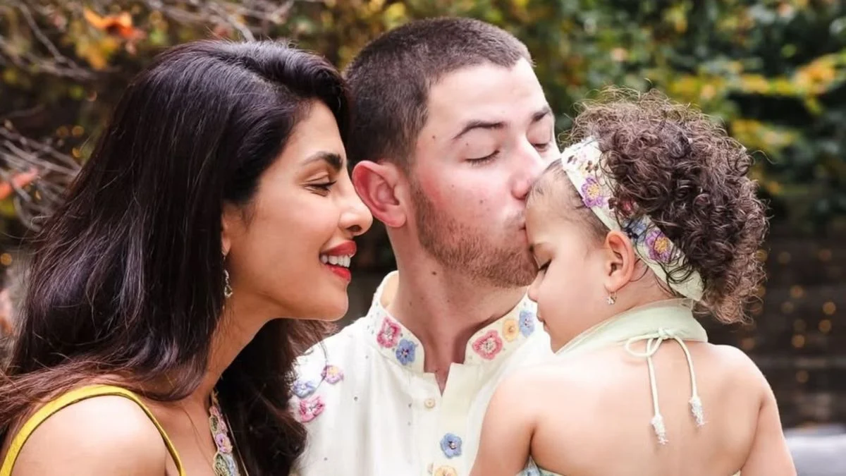 Nick Jonas and Priyanka Chopra Jonas sharing a tender moment with their daughter, Malti Marie, during a family celebration.