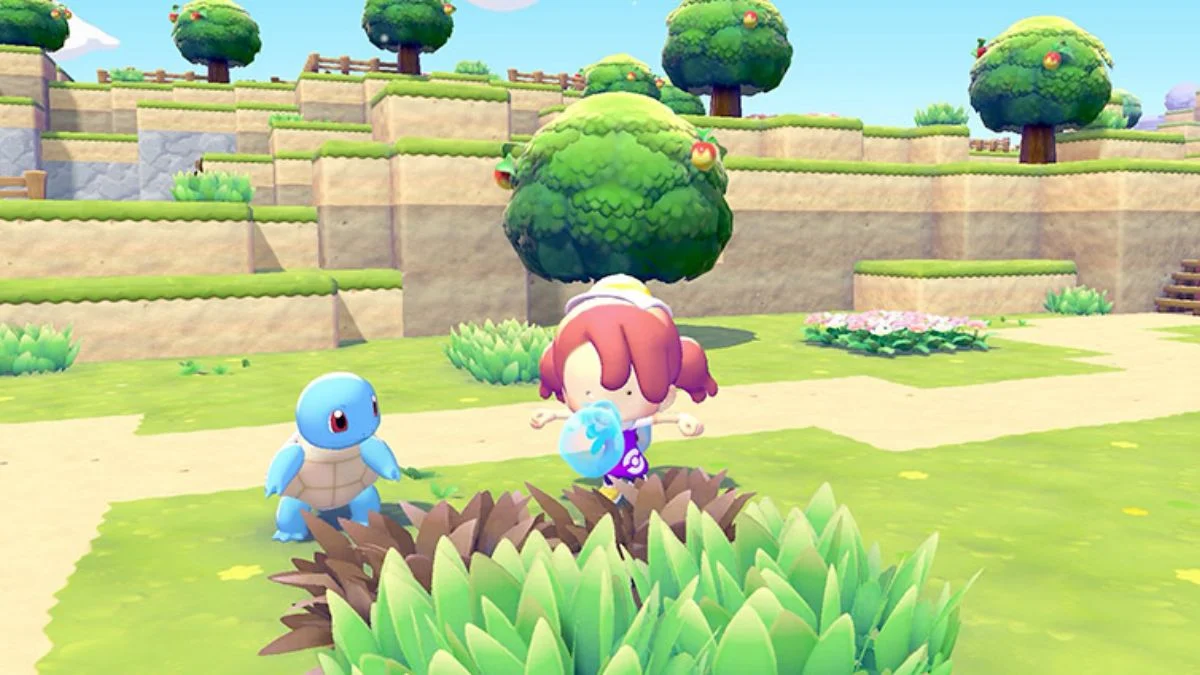 A red-haired player character interacting with a Squirtle in the colorful open-world environment of Pokémon Pokopia on Nintendo Switch 2.