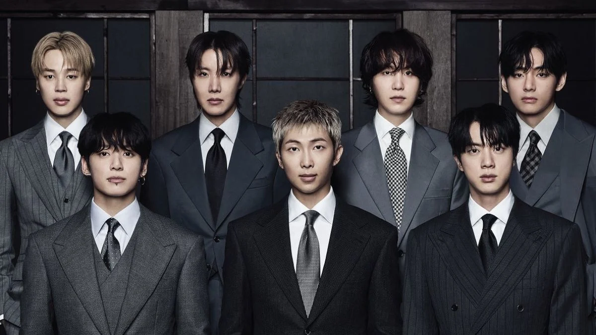 BTS members Jimin, j-hope, SUGA, V, Jung Kook, RM, and Jin wearing formal grey and black suits for the ARIRANG album concept.