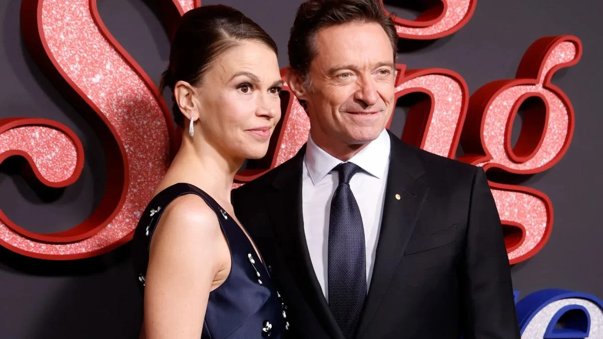 Hugh Jackman and Sutton Foster smiling together on the red carpet at the Song Sung Blue premiere during AFI Fest.