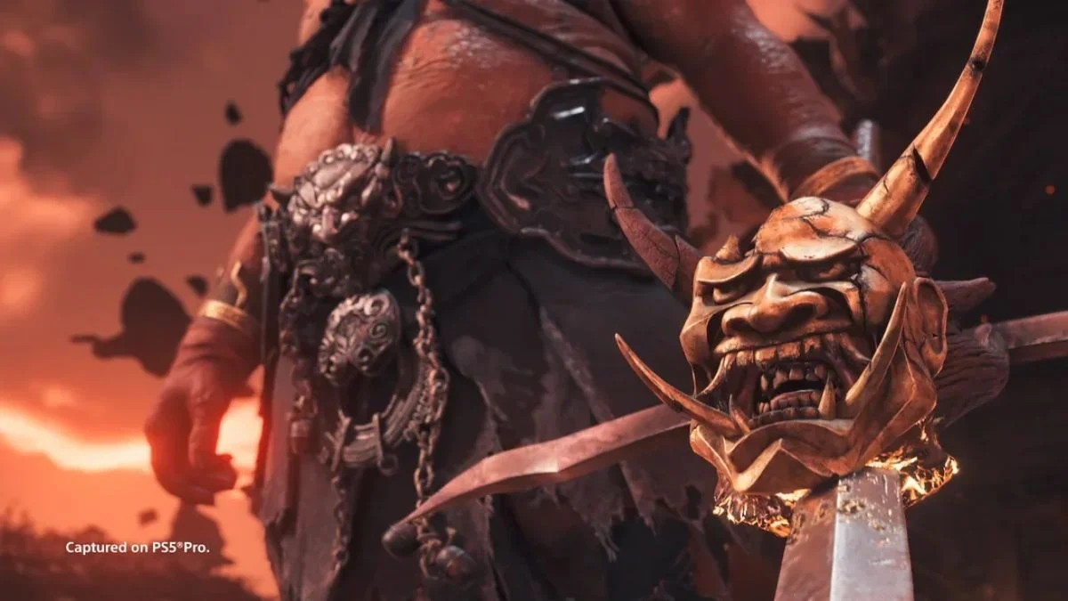 Close-up of a demonic Oni boss in Ghost of Yōtei Legends holding a sword with a severed hannya mask.