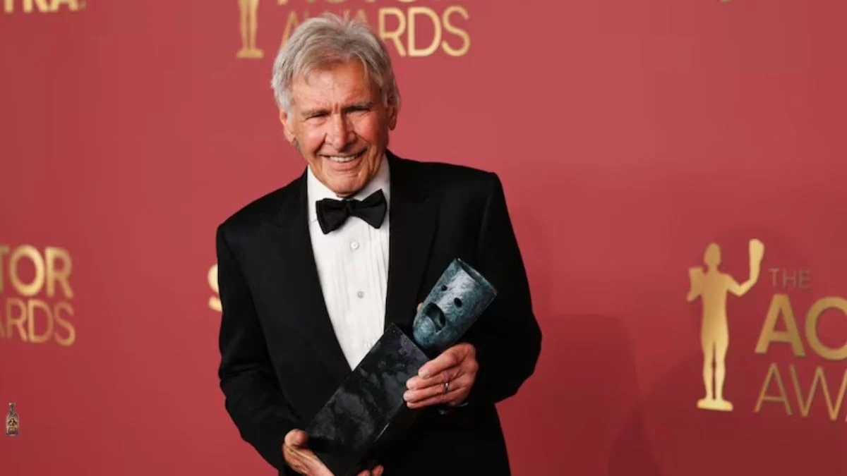 Harrison Ford smiling and holding the SAG-AFTRA Life Achievement Award trophy at the 2026 Actor Awards.