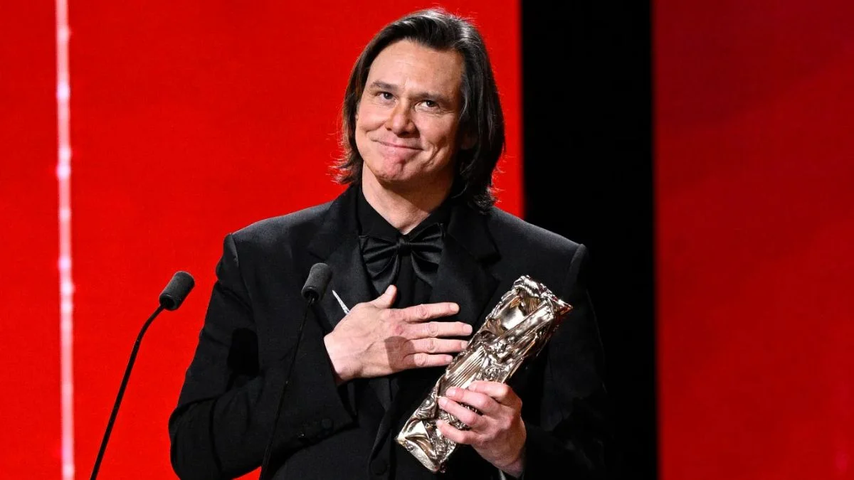 Jim Carrey holding the Honorary César Award on stage in Paris 2026.