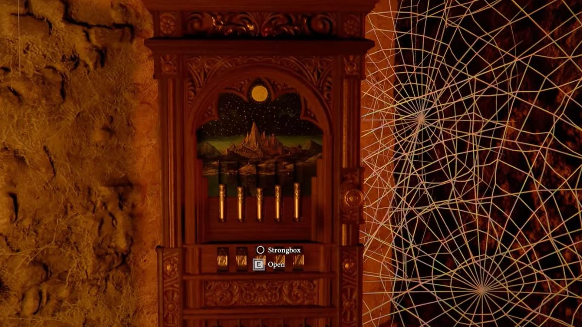 The five-cylinder tumbler puzzle on the Arboria Castle strongbox featuring a mountain and moon painting.