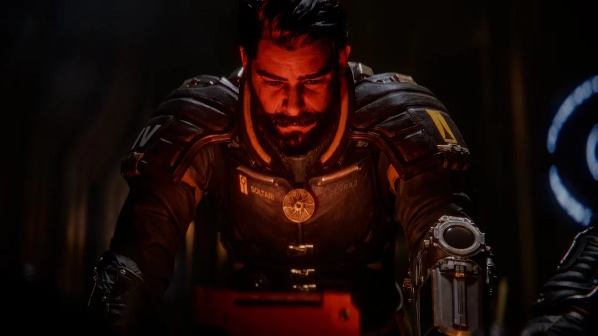 Arjun Devraj, played by Rahul Kohli, looking down solemnly in a cinematic from Saros.