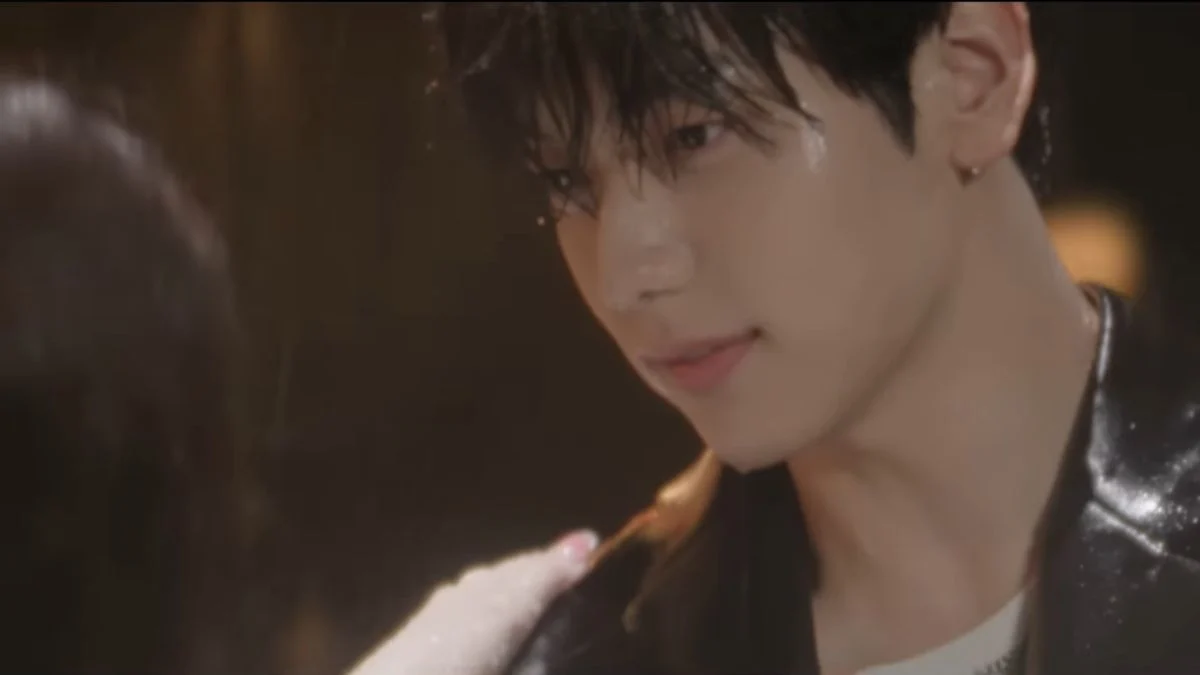 A close-up shot of TXT member Soobin with wet hair and a slight smile, looking emotionally at someone off-camera in the Stick With You teaser.