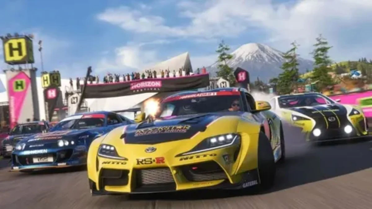 An action-heavy, in-game screenshot showcasing tire smoke and drift culture in Forza Horizon 6. A heavily modified yellow Toyota Supra with a Rockstar Energy Drink livery leads the pack around a tarmac bend. It is flanked by a blue Nissan Skyline on the left and a white Lexus on the right. In the background, festival stands with "H" banners are packed with spectators beneath a clear sky and the iconic snow-capped peaks of Mount Fuji.