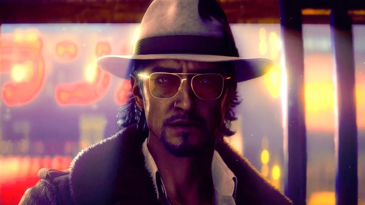 Yu Shinjo wearing a fedora and sunglasses in a neon-lit street in Stranger Than Heaven.