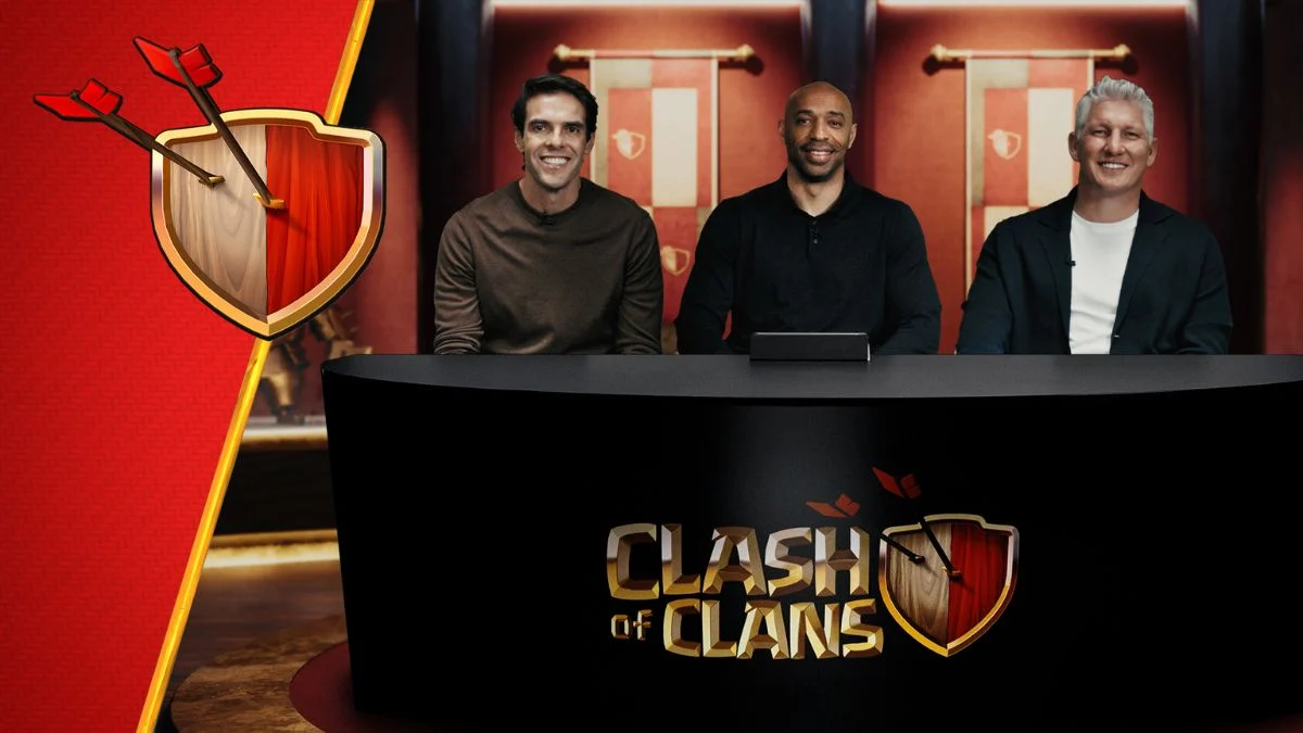 Football legends Kaka, Thierry Henry, and Bastian Schweinsteiger sitting behind a Clash of Clans branded desk for the It's In Your Hands campaign.