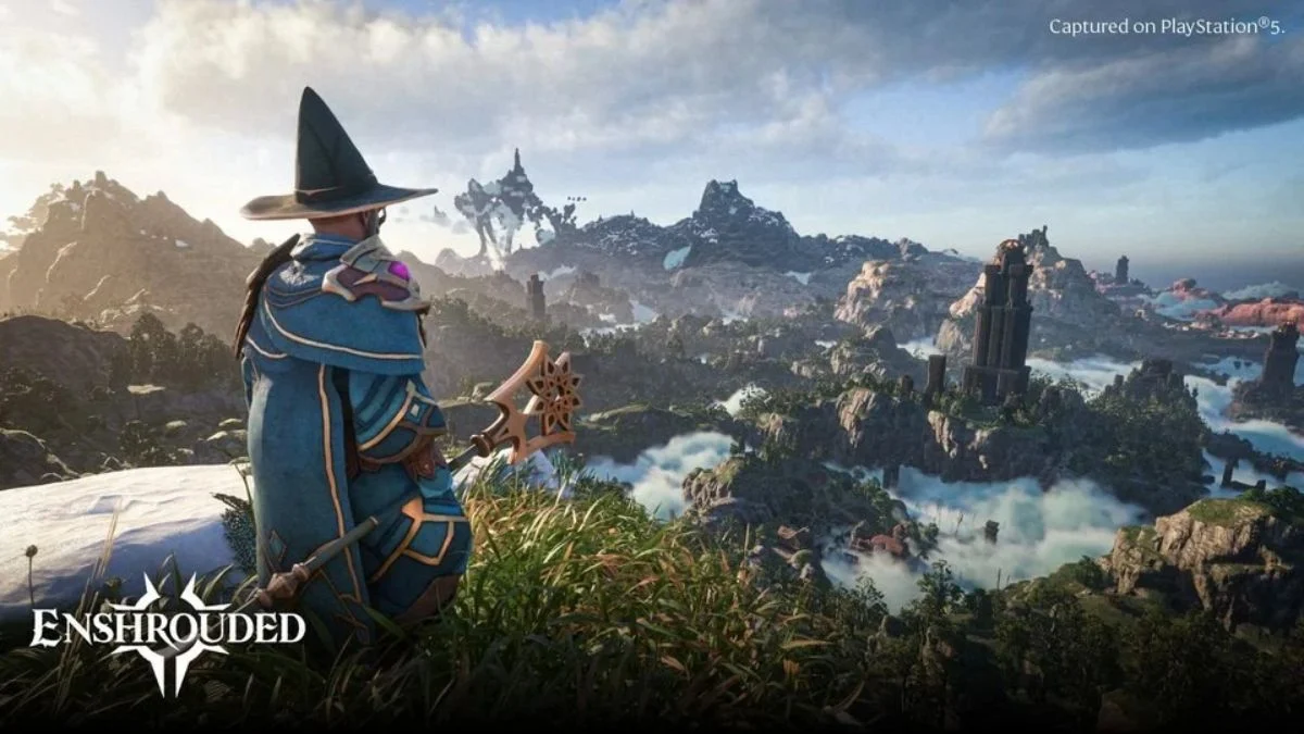 A Flameborn character in blue wizard robes and a pointed hat overlooking the vast, fog-covered open world of Embervale in Enshrouded 1.0.