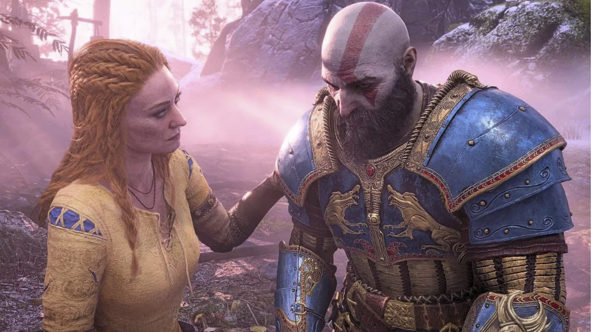 Kratos in ornate blue and gold armor looking down while Faye places a comforting hand on his shoulder in a misty forest.