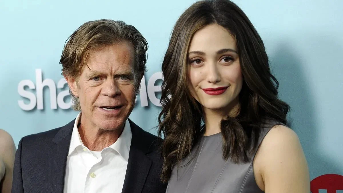 William H Macy and Emmy Rossum posing together at a Shameless promotional event