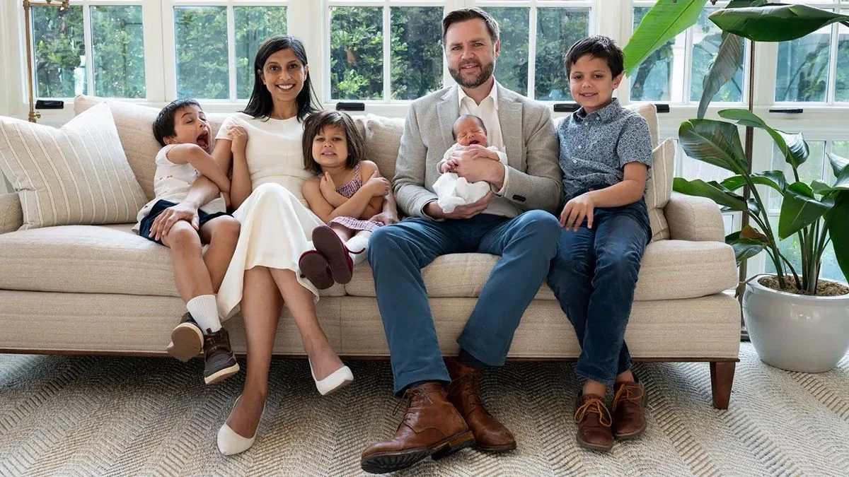 Vice President JD Vance and Second Lady Usha Vance smile on a white couch with their four children, including newborn baby Alec Neel Vance.