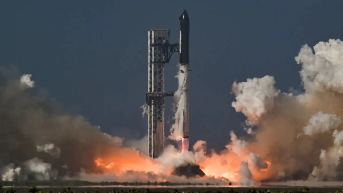 The massive Starship rocket lifting off from its launch tower at Starbase, Texas, surrounded by large plumes of fire and smoke.