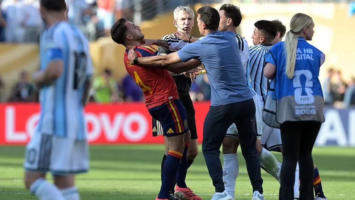 chaotic on-field confrontation showing a Spain player being grabbed by the throat by an Argentina player while coaches and referees try to break up the scuffle.