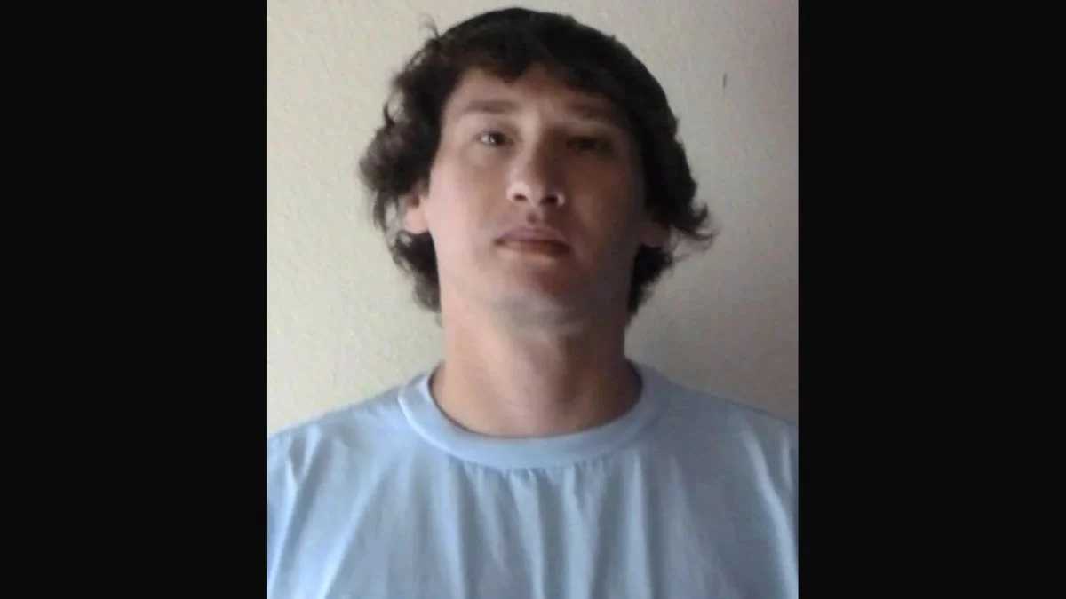 Mugshot portrait of Aaron Farinacci wearing a light blue t-shirt.