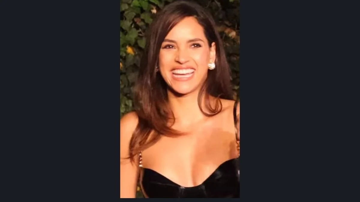 Adria Arjona smiling brightly on a red carpet event.
