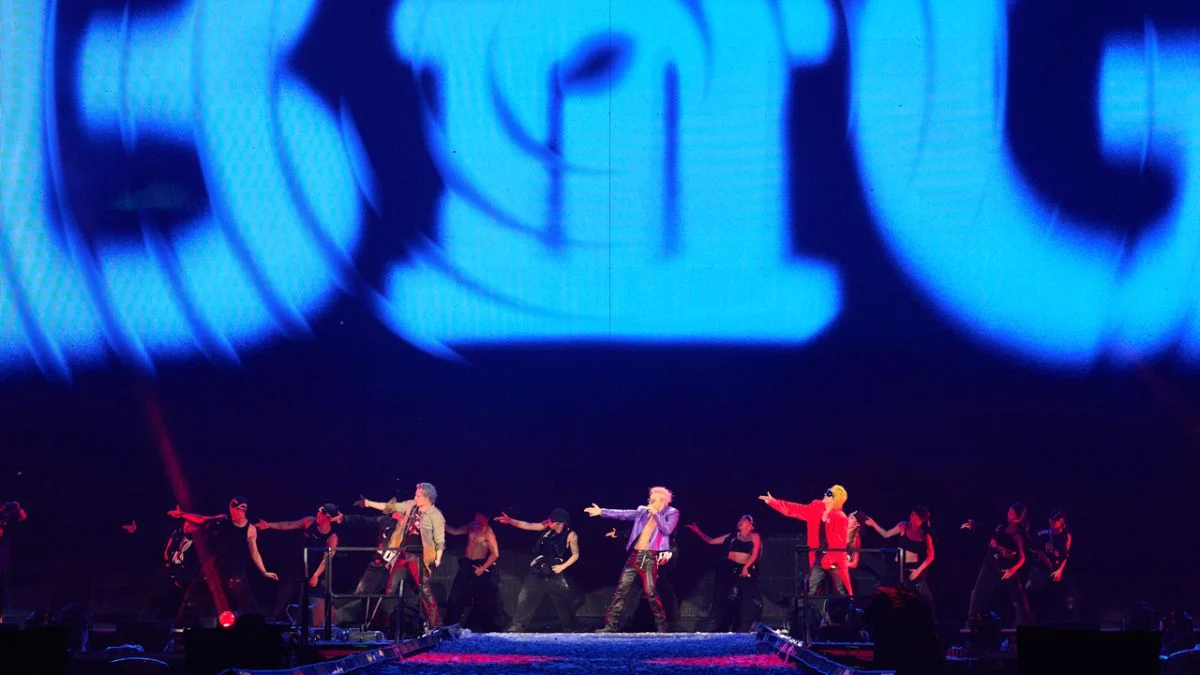 BIGBANG members G-Dragon, Taeyang, and Daesung performing live with backup dancers on stage at Goyang Stadium during their 20th Anniversary XX : COSMOS World Tour.