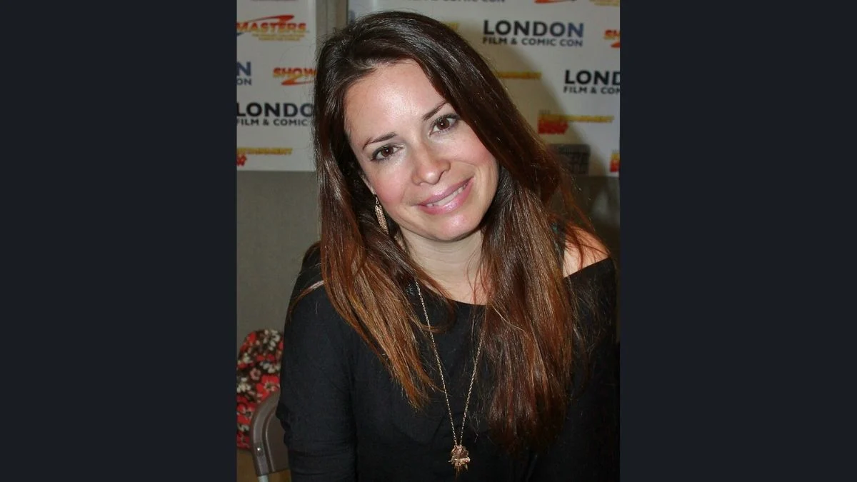 Holly Marie Combs smiling at a fan event in a classic portrait photo