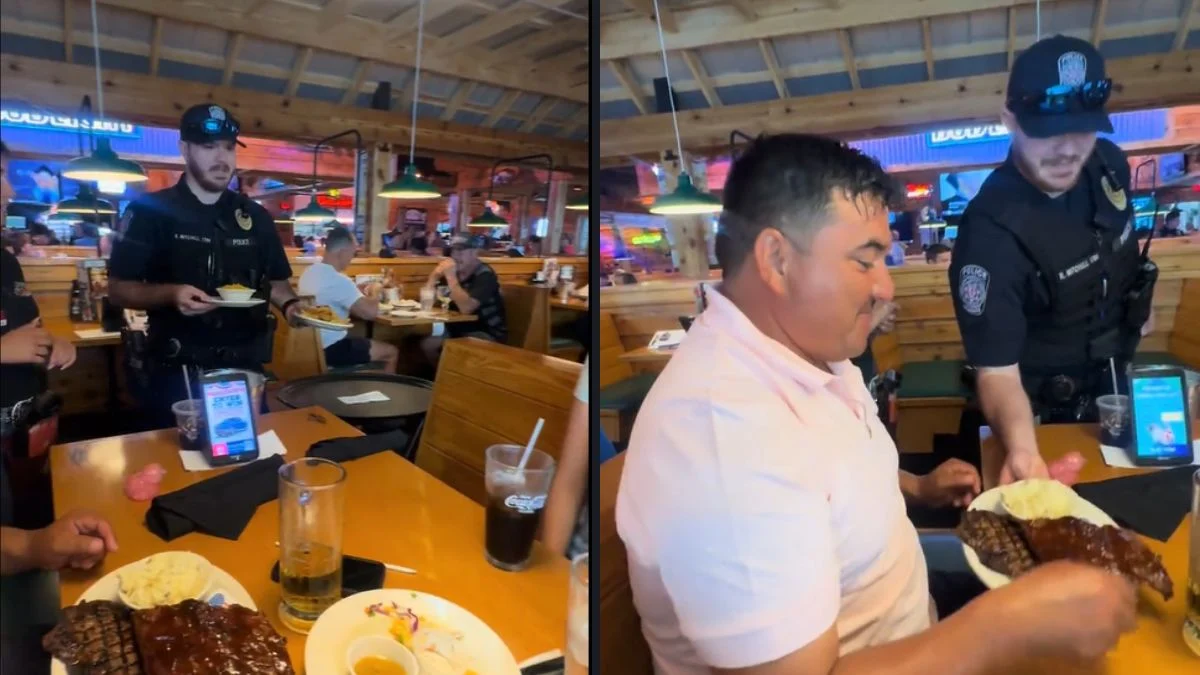 Uniformed Texas police officer serving food to restaurant diners during Texas Roadhouse Tip-A-Cop event