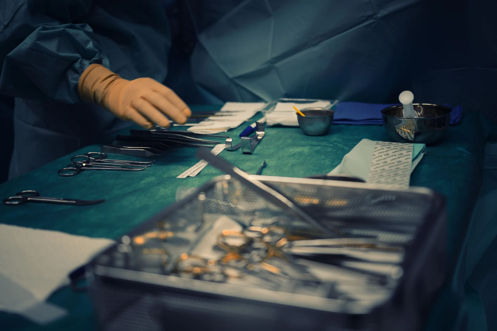 Surgical instruments arranged on a sterile green cloth in an operating theatre during an emergency surgery