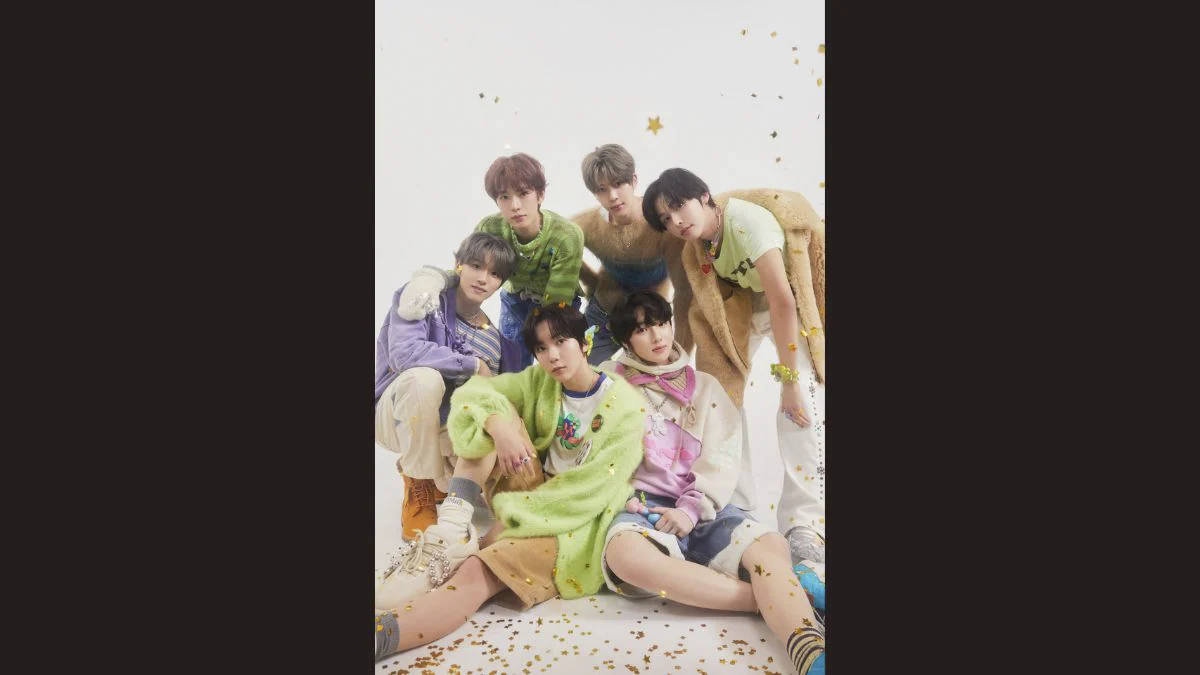 Members of K-pop group NCT WISH posing together in colorful pastel sweaters and casual outfits for promotional photos.