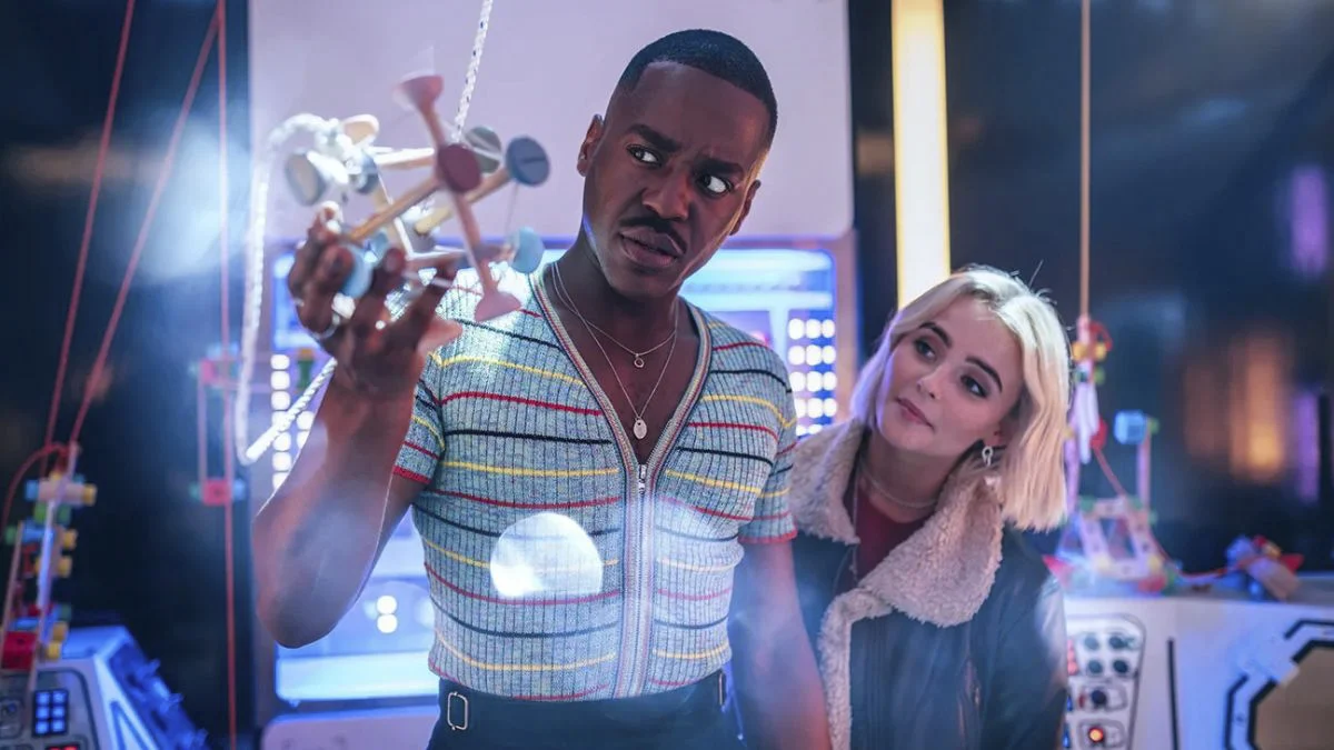 Ncuti Gatwa as the Fifteenth Doctor and Millie Gibson as Ruby Sunday examining an object in Doctor Who.