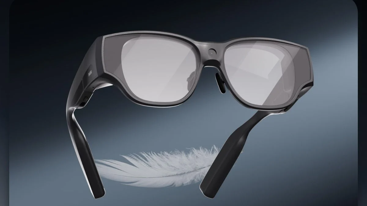 Black INMO Air3 smart glasses suspended above a feather, highlighting the lightweight design of the recalled AR glasses.