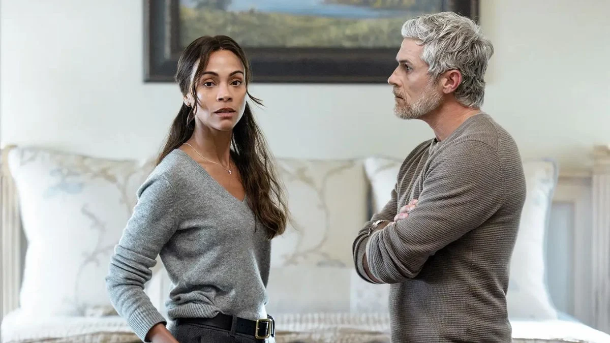 Zoe Saldaña as Joe McNamara standing beside Dave Annable as Neal McNamara during an intense conversation