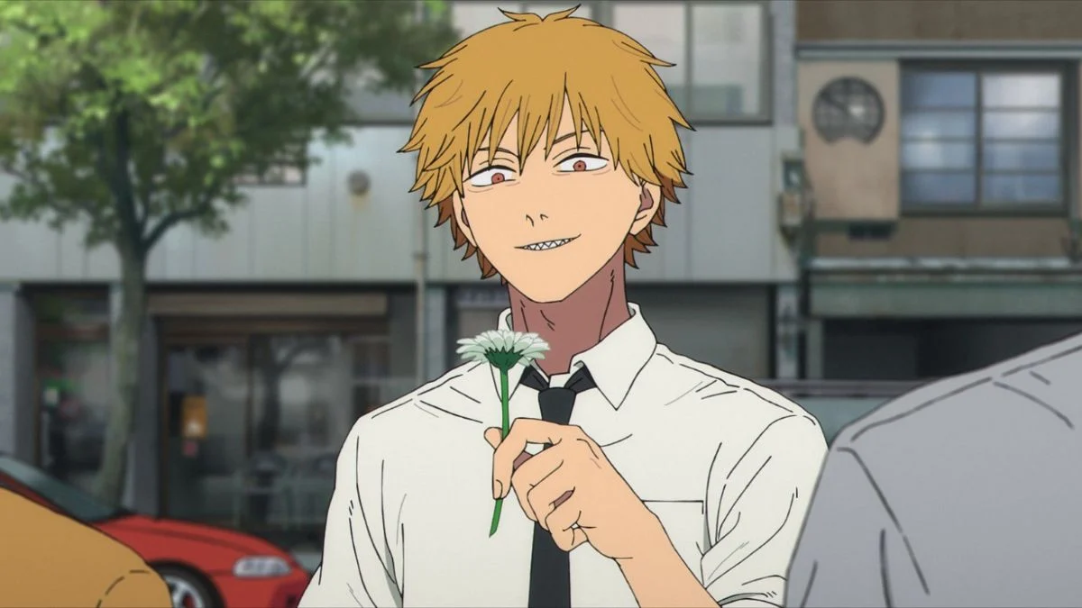 Anime screenshot of Denji smiling while holding a white flower in Chainsaw Man produced by MAPPA.