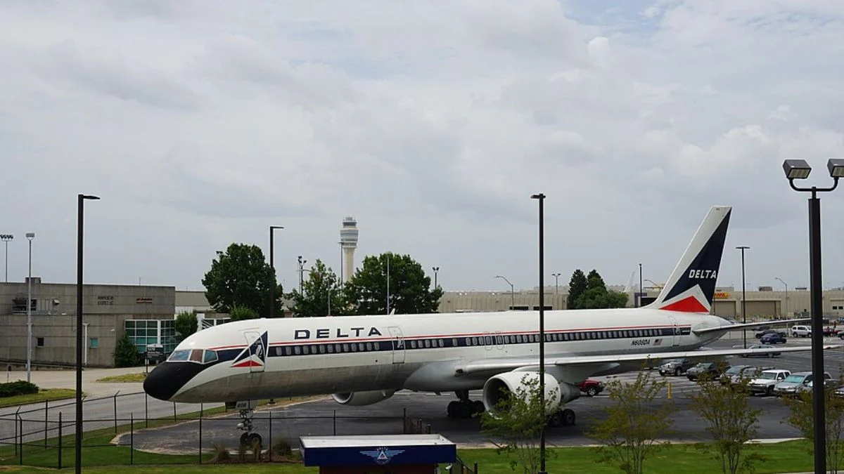 Side view profile of a retro-painted Delta Air Lines jetliner on the tarmac