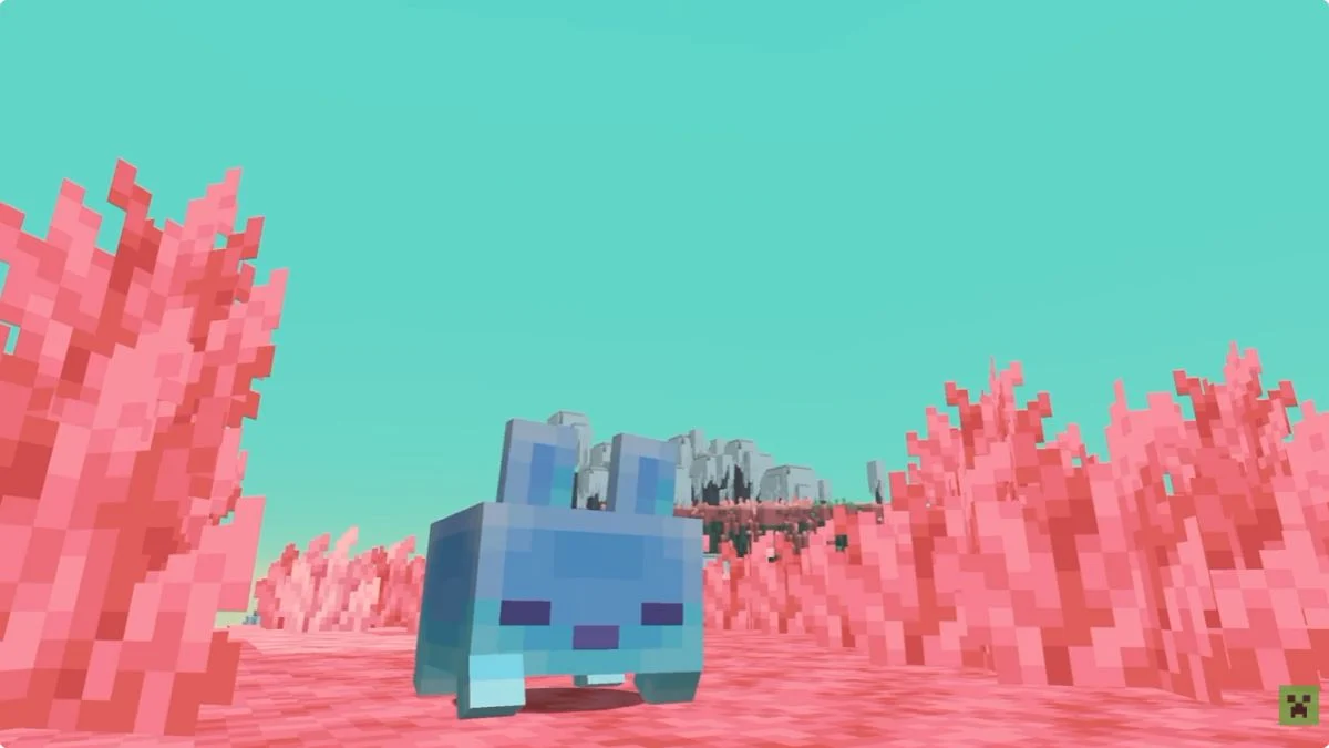 A cute blue rabbit-like mob standing in a vibrant pink biome under a cyan sky in Minecraft's new Sift dimension.