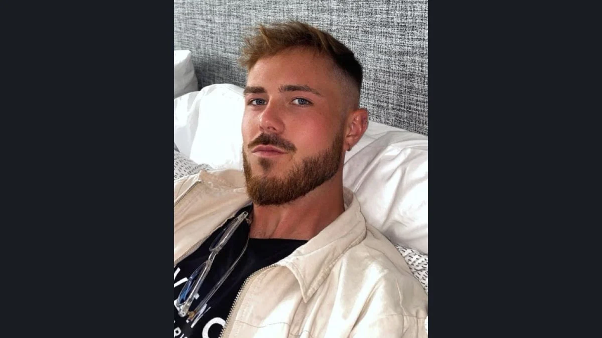 Below Deck Mediterranean star Nathan Gallagher posing for a photo while lying down